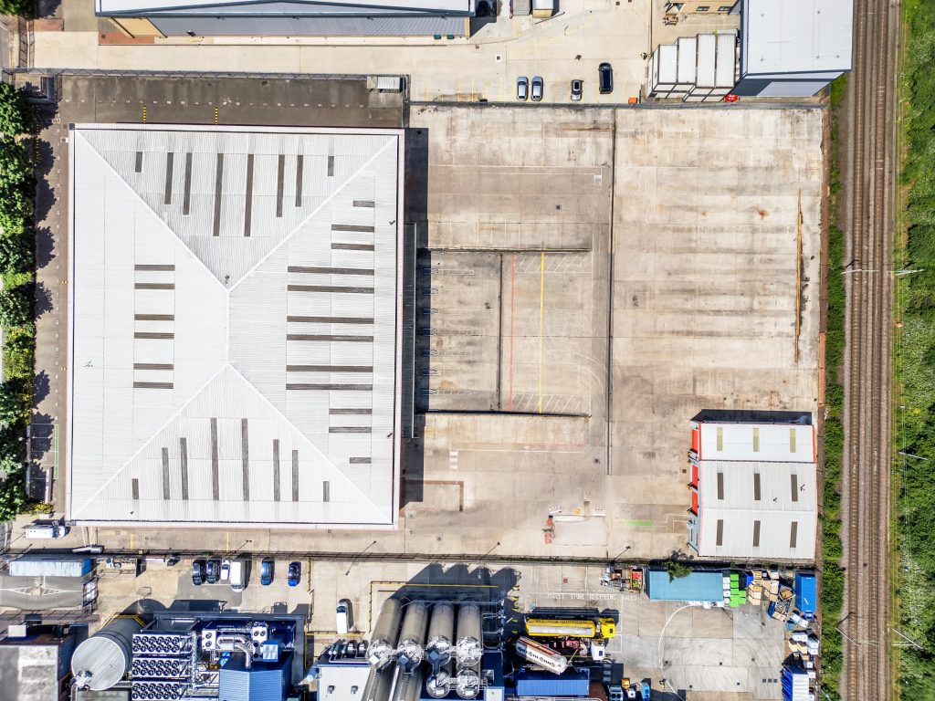 a birds eye view of a modern industrial building on a sunny day